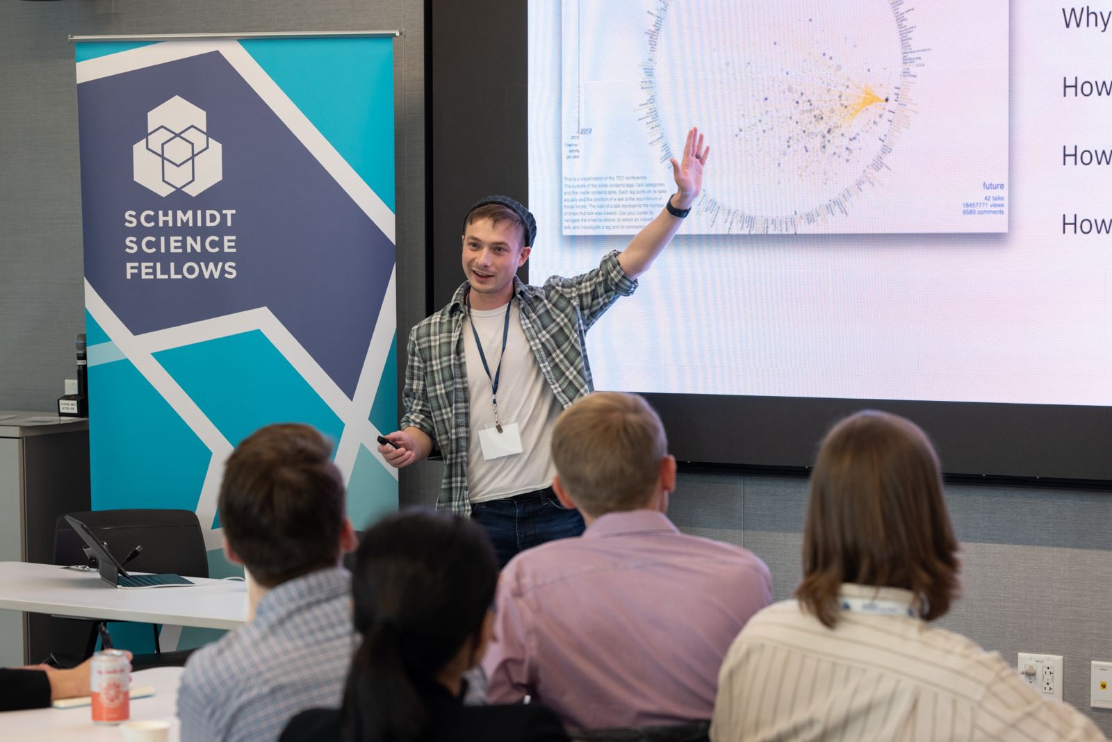 Sam standing and gesturing at workshop