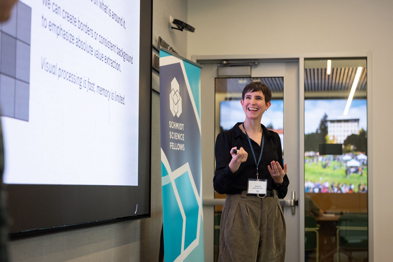 Amanda standing at workshop and smiling